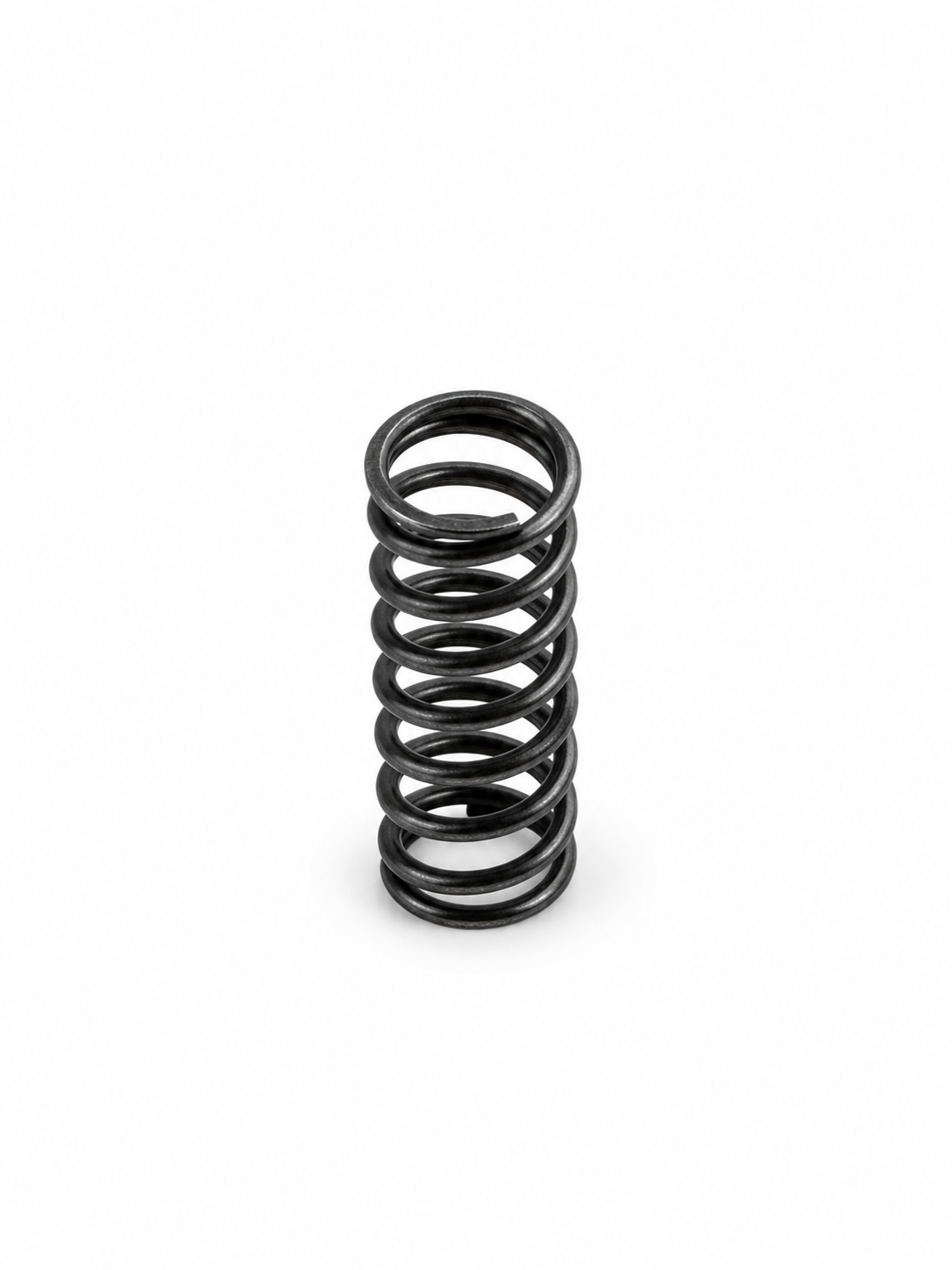 Replacement compression spring standing upright on white background