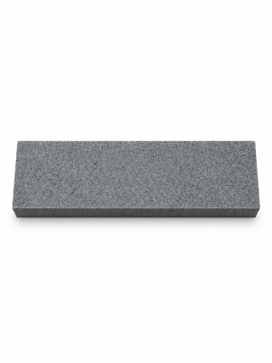 Compact gray sharpening stone, top view on white background