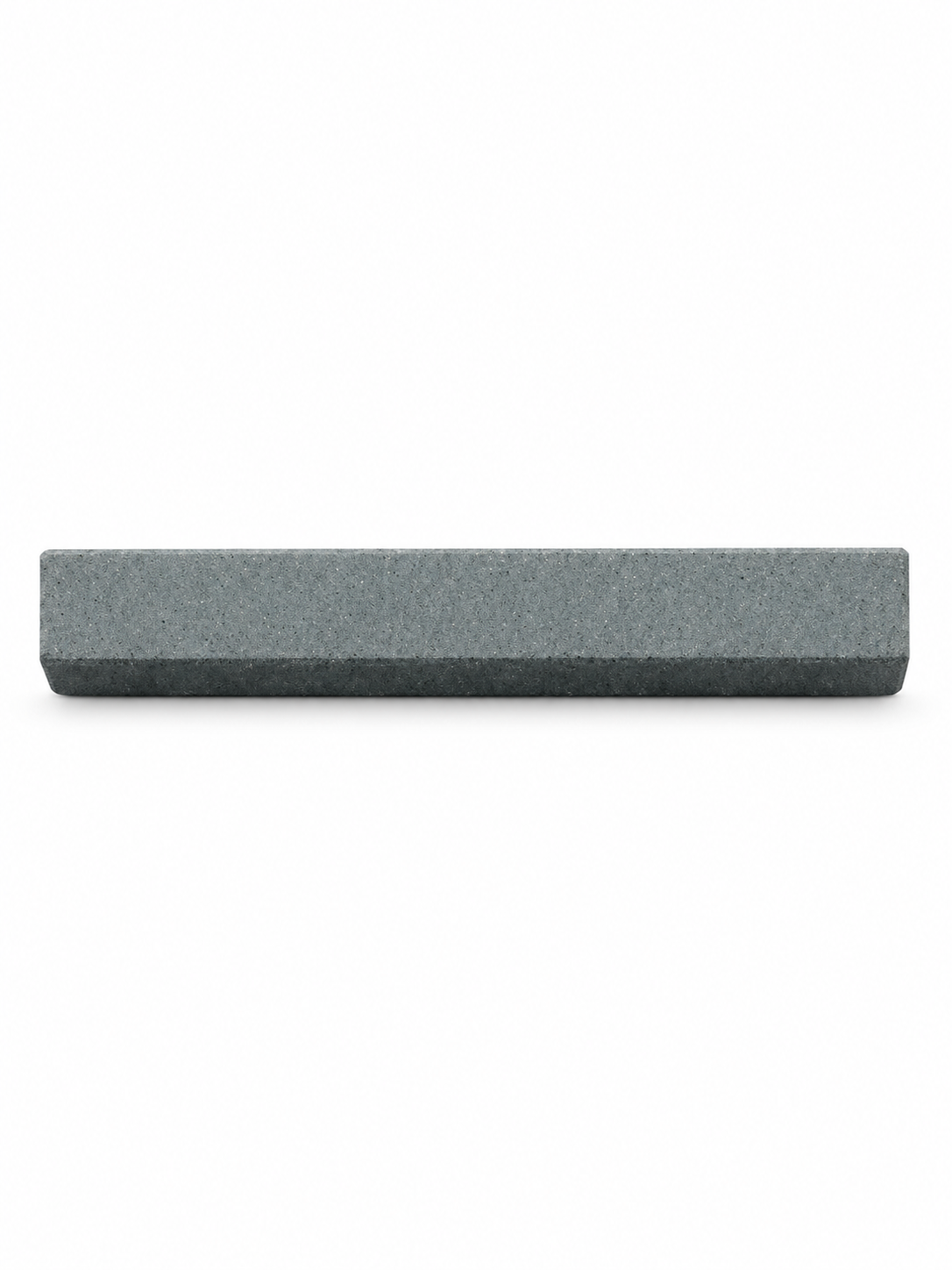 Compact gray sharpening stone, side view on white background