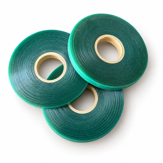 Three genuine green Tie-It plant tie tape rolls on white background